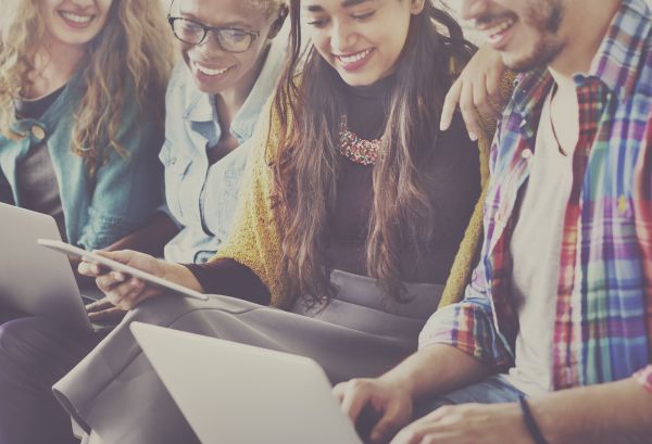 Millennials working together on a Mac