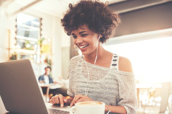 Millennial woman working on laptop at a coffee shop