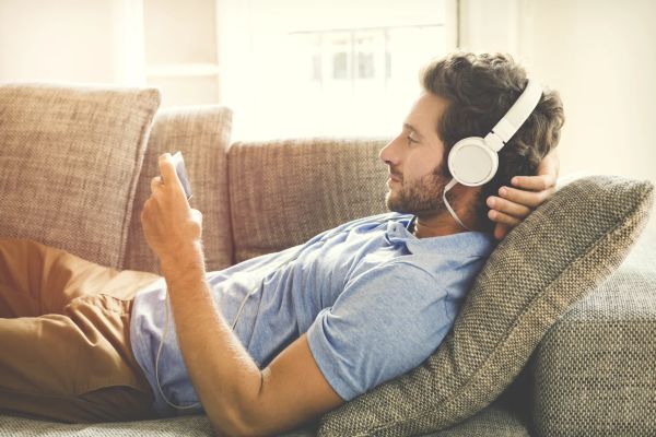 Millennial man streaming a video on phone