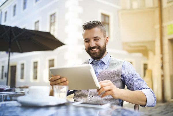 Millennial man looking at a tablet